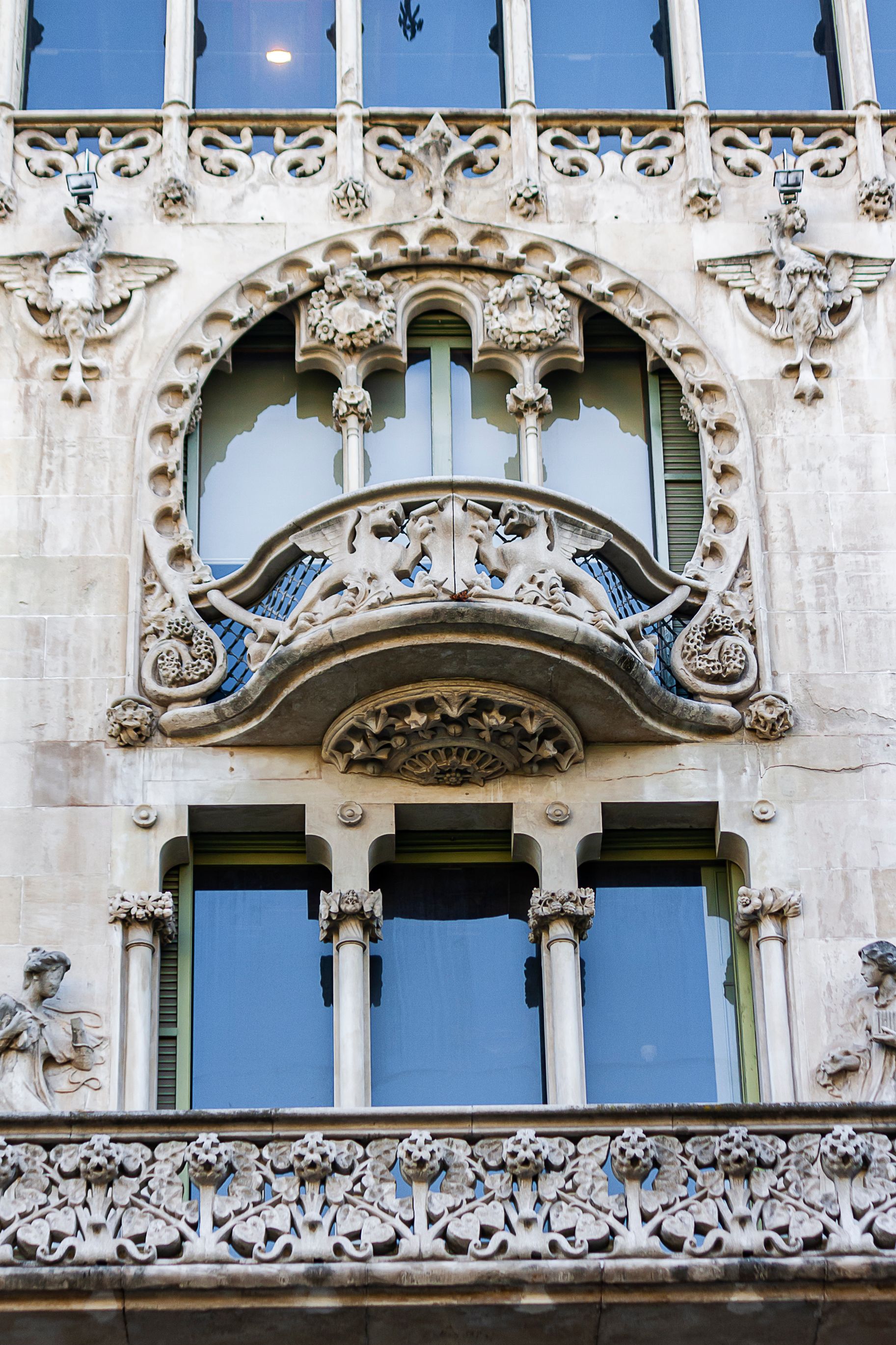 Carved Modernista stone facade with floral tracery, griffins and sculpted figures